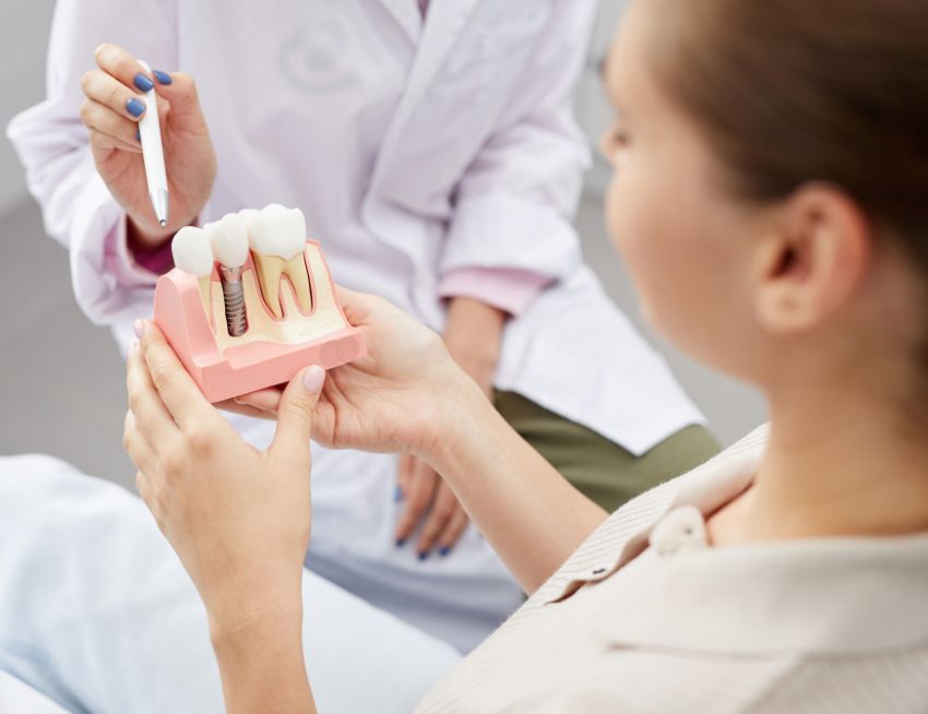Dentist showing dental implant process