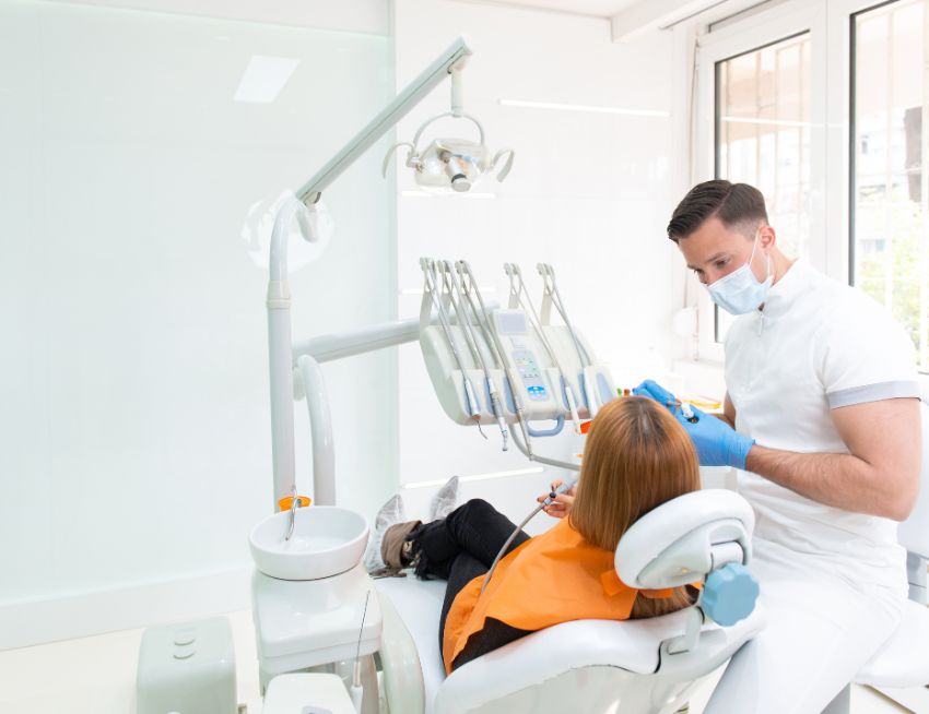 Dentist and patient talking about dental implant complications