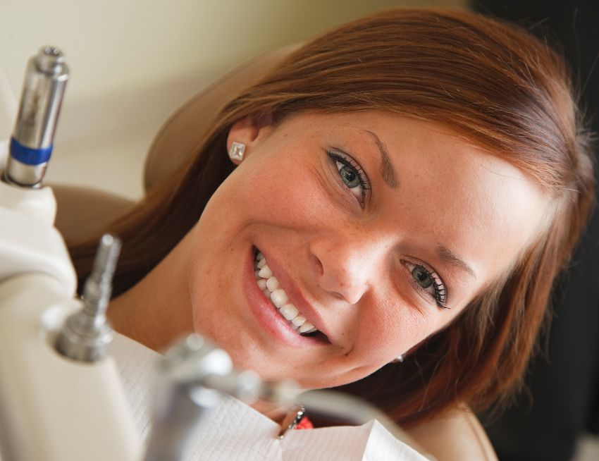 Happy American dental patient - dental crown materials in the blog post 